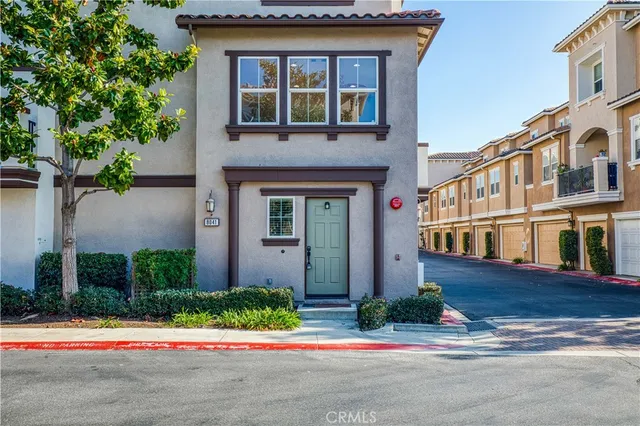 a front view of a residential apartment building with a yard