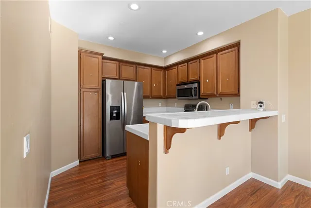 a kitchen with stainless steel appliances granite countertop a refrigerator and a sink
