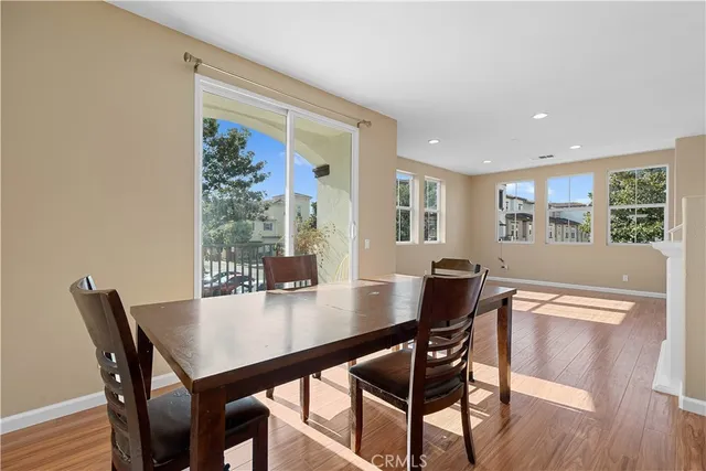 a dining room with furniture and wooden floor