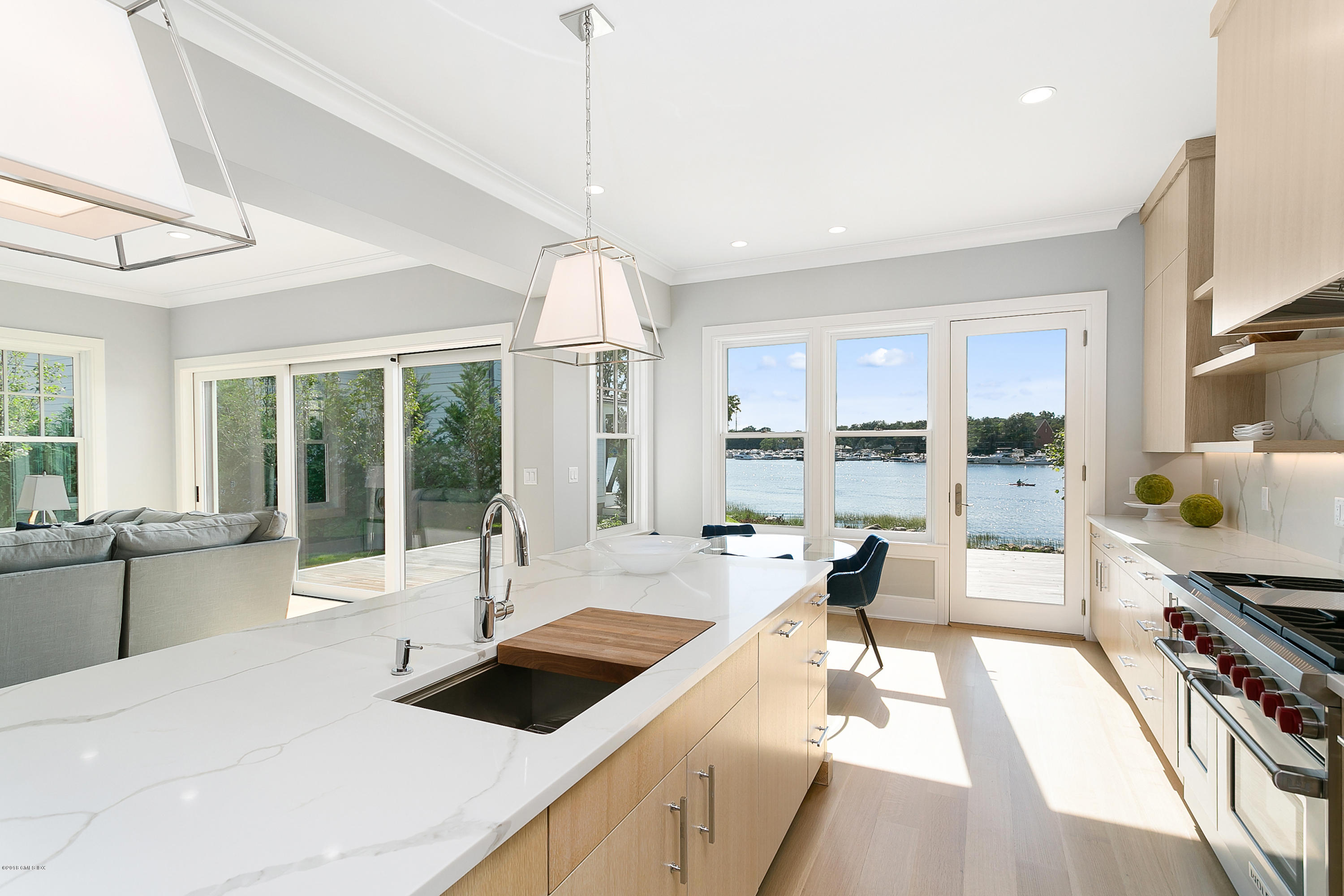 27 Bayside Terrace Riverside, CT 06878 - Photo 13 of 56 a large kitchen with kitchen island a large window cabinets a sink and stainless steel appliances