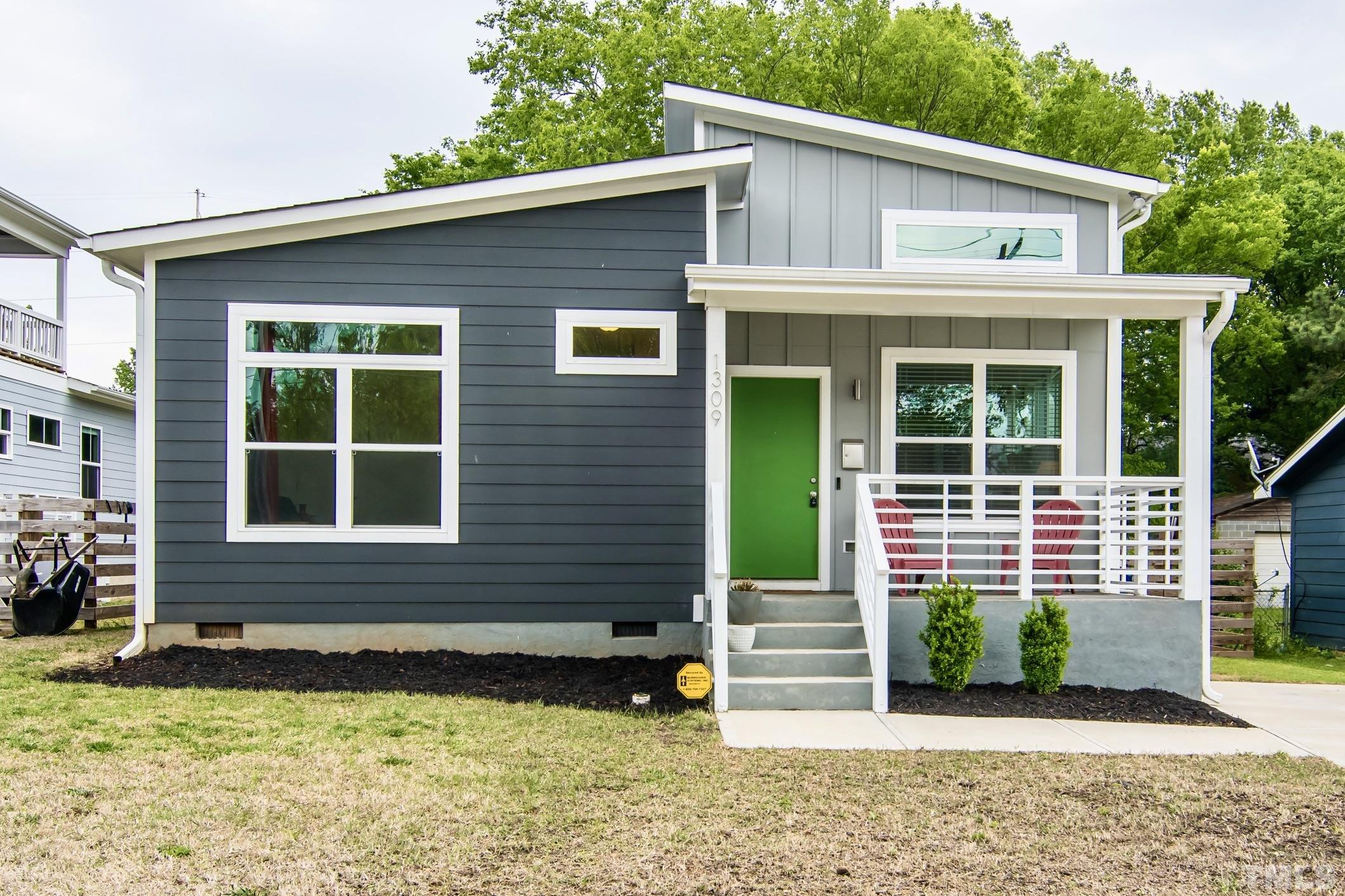 1309 South East Street Raleigh, NC 27601 - Photo 1 of 29 a front view of a house with a garden