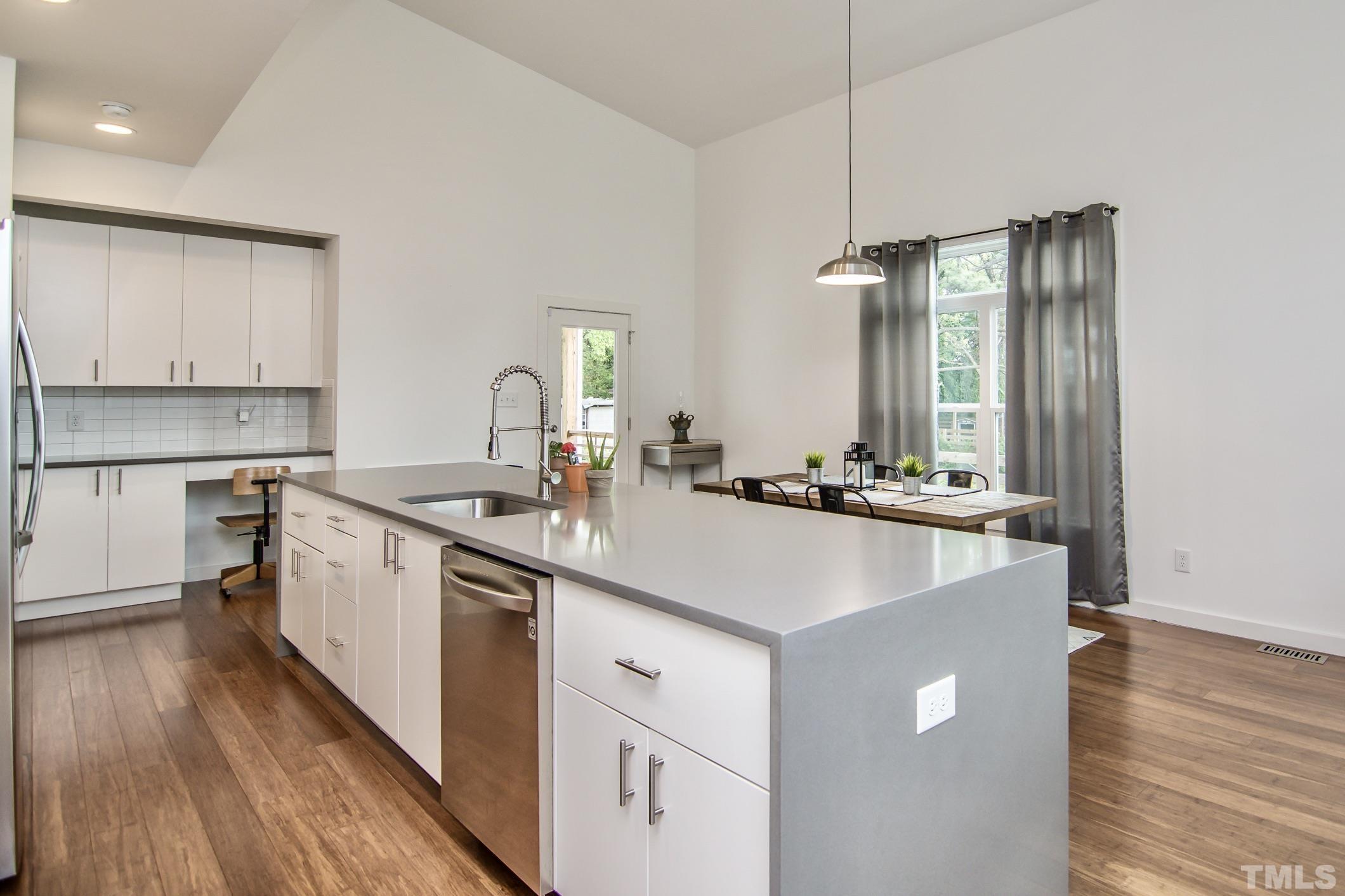1309 South East Street Raleigh, NC 27601 - Photo 12 of 29 a kitchen with kitchen island a sink and wooden floor