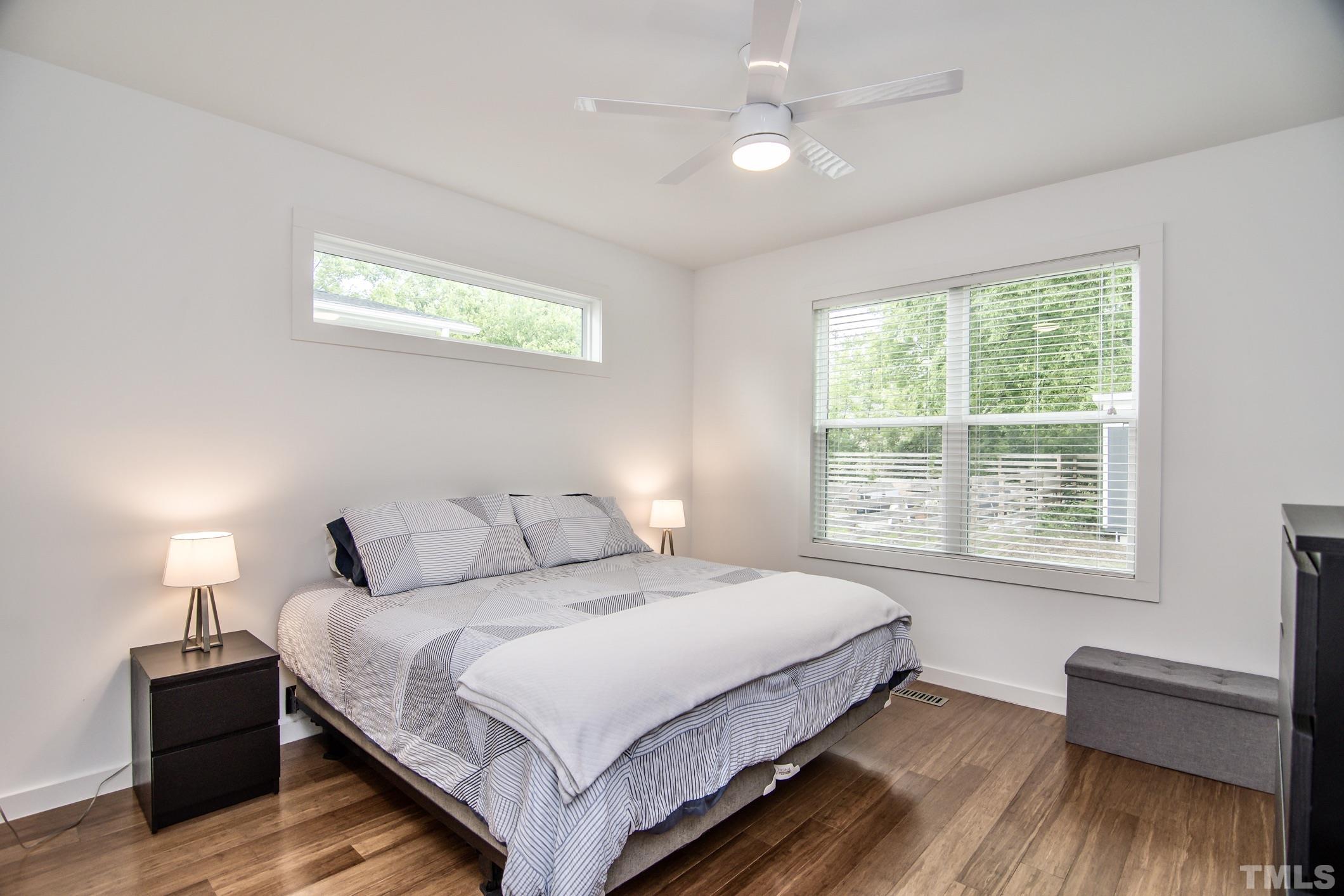 1309 South East Street Raleigh, NC 27601 - Photo 14 of 29 a bedroom with a bed and wooden floor