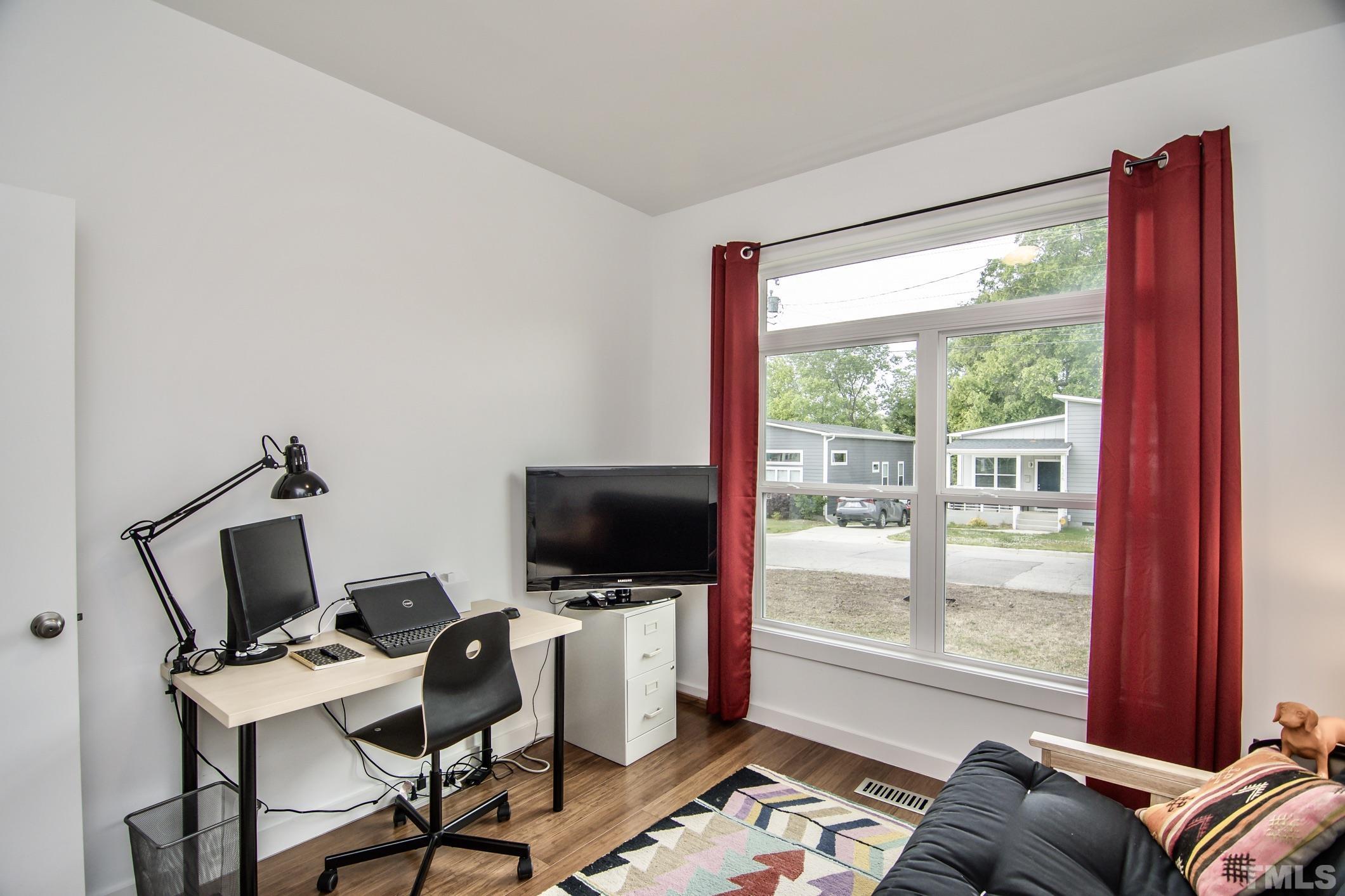 1309 South East Street Raleigh, NC 27601 - Photo 19 of 29 a view of a workspace with furniture and a window