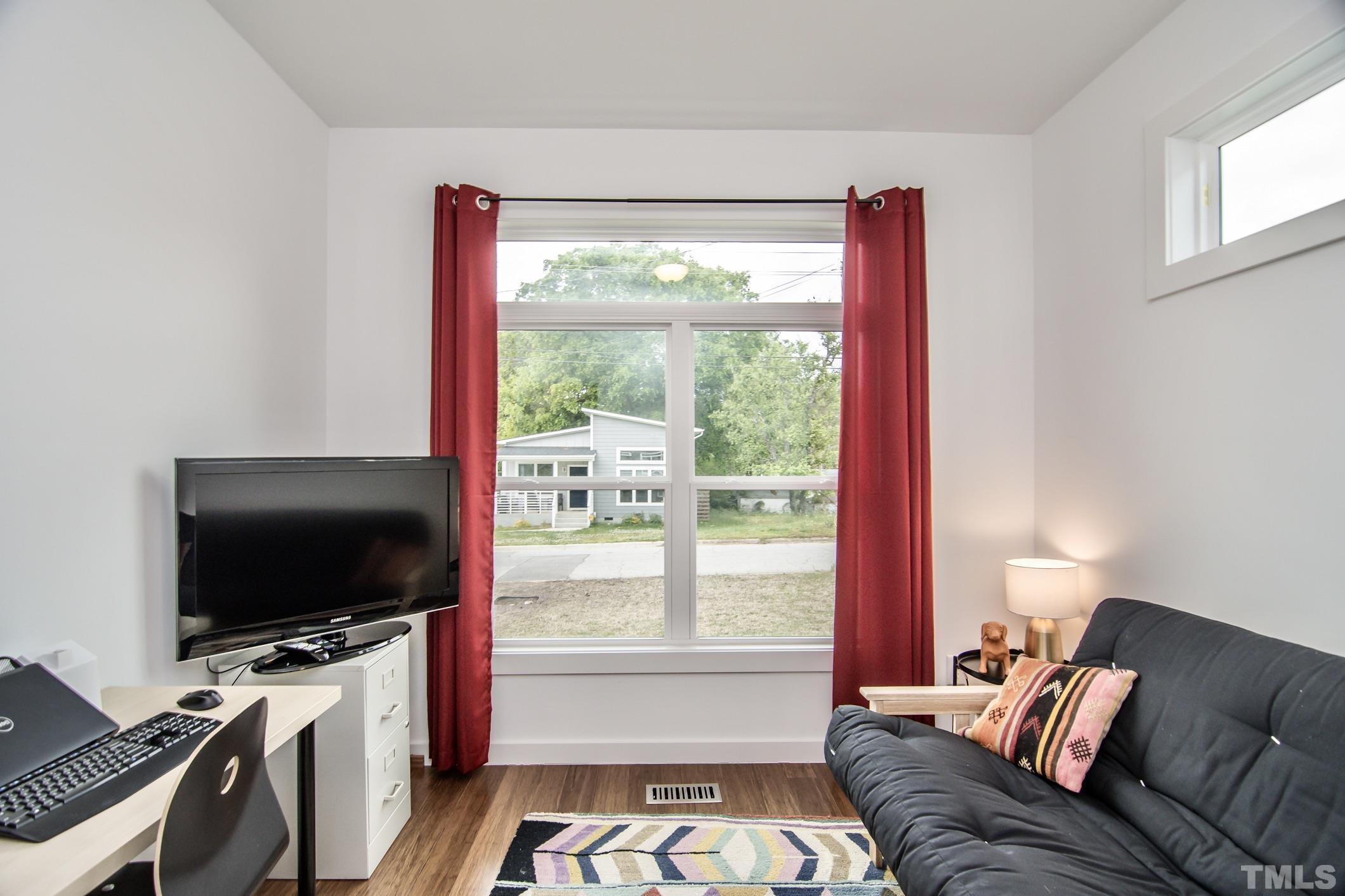 1309 South East Street Raleigh, NC 27601 - Photo 20 of 29 a living room with furniture and a flat screen tv