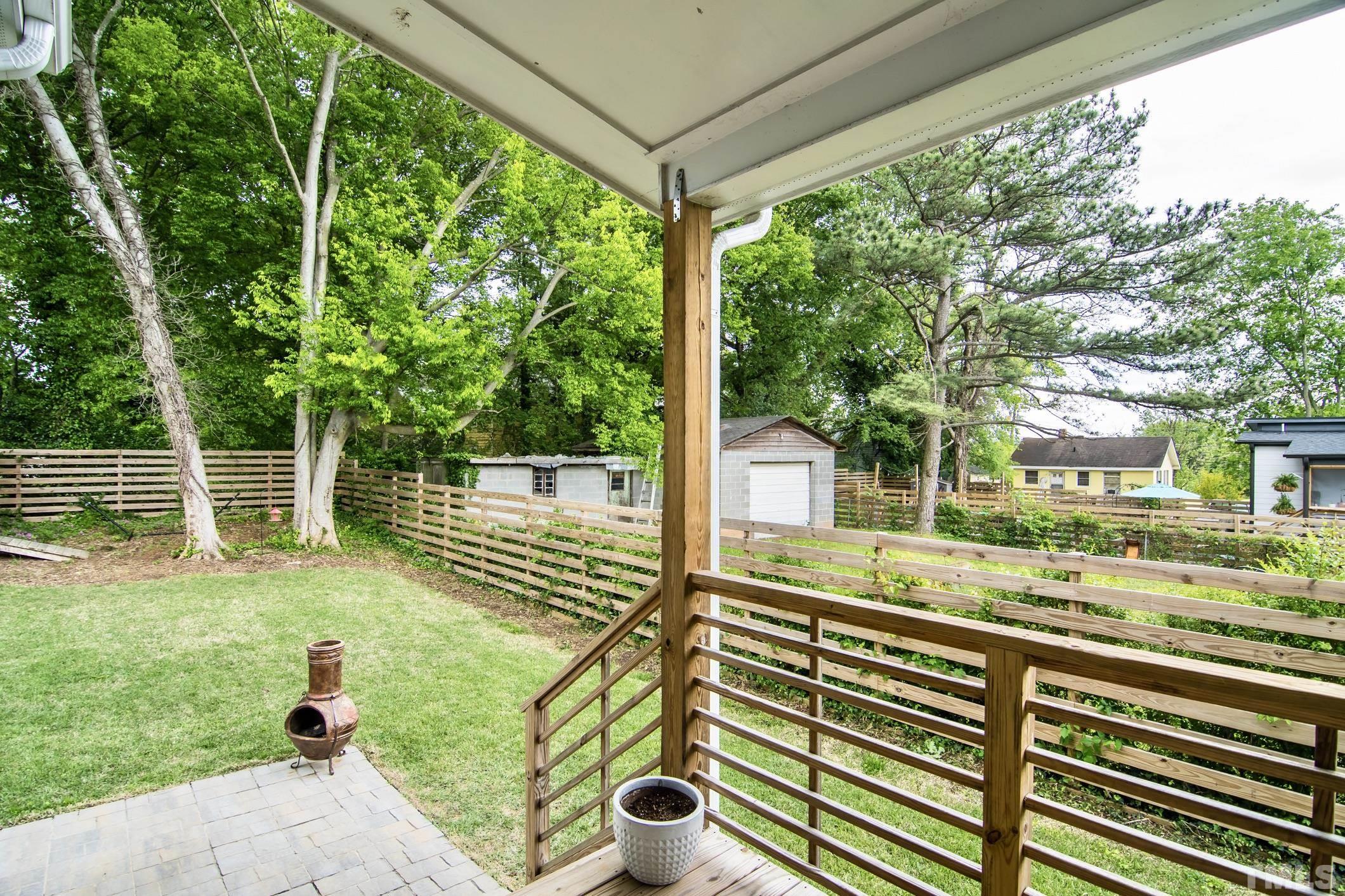 1309 South East Street Raleigh, NC 27601 - Photo 24 of 29 a view of a porch with furniture and garden