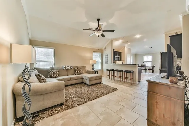 a living room with furniture and a flat screen tv