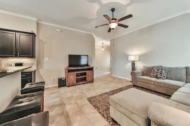 a kitchen with refrigerator and chairs