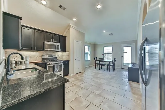 a stove top oven sitting inside of a kitchen