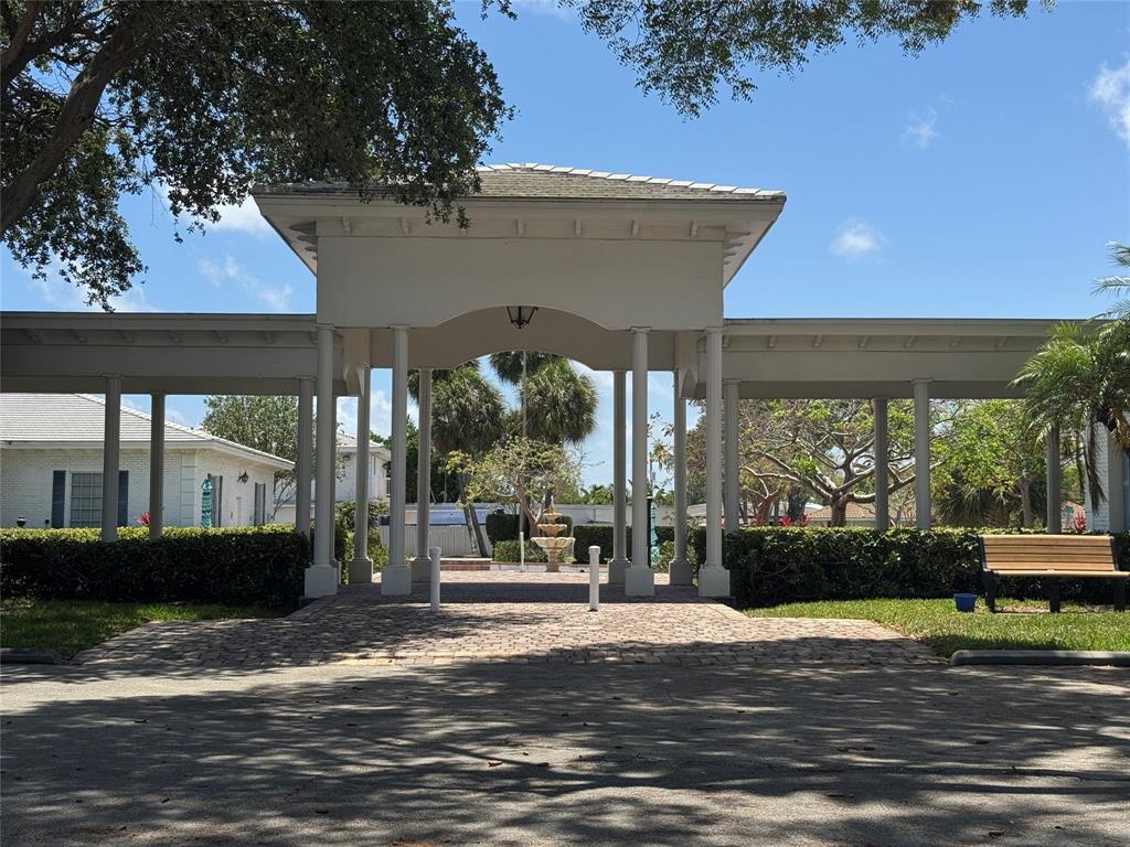 2220 Northeast 68th Street, Unit 1031 Fort Lauderdale, FL 33308 - Photo 11 of 12 a front view of a house with a garden