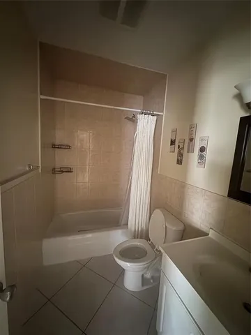 a bathroom with a shower and a toilet
