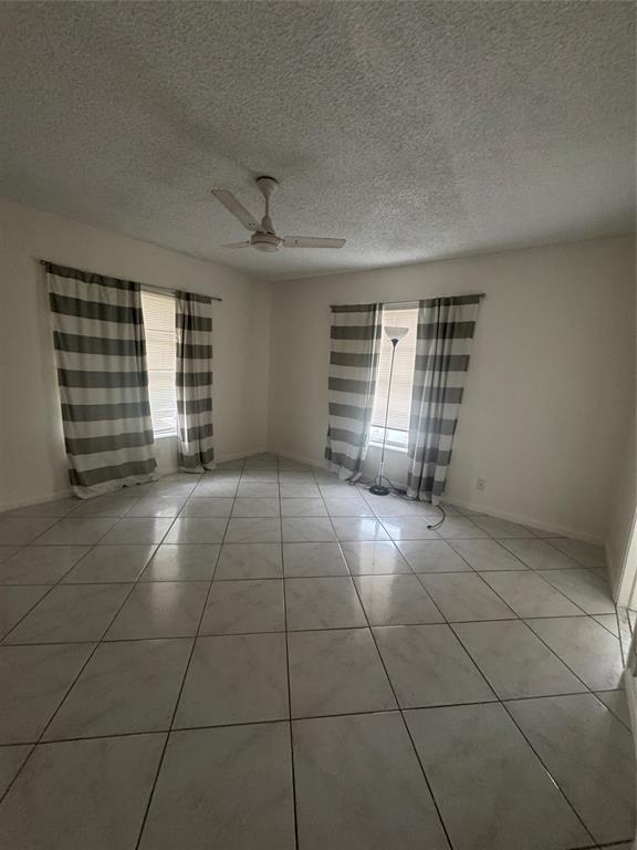 2220 Northeast 68th Street, Unit 1031 Fort Lauderdale, FL 33308 - Photo 7 of 12 a view of an empty room with a window
