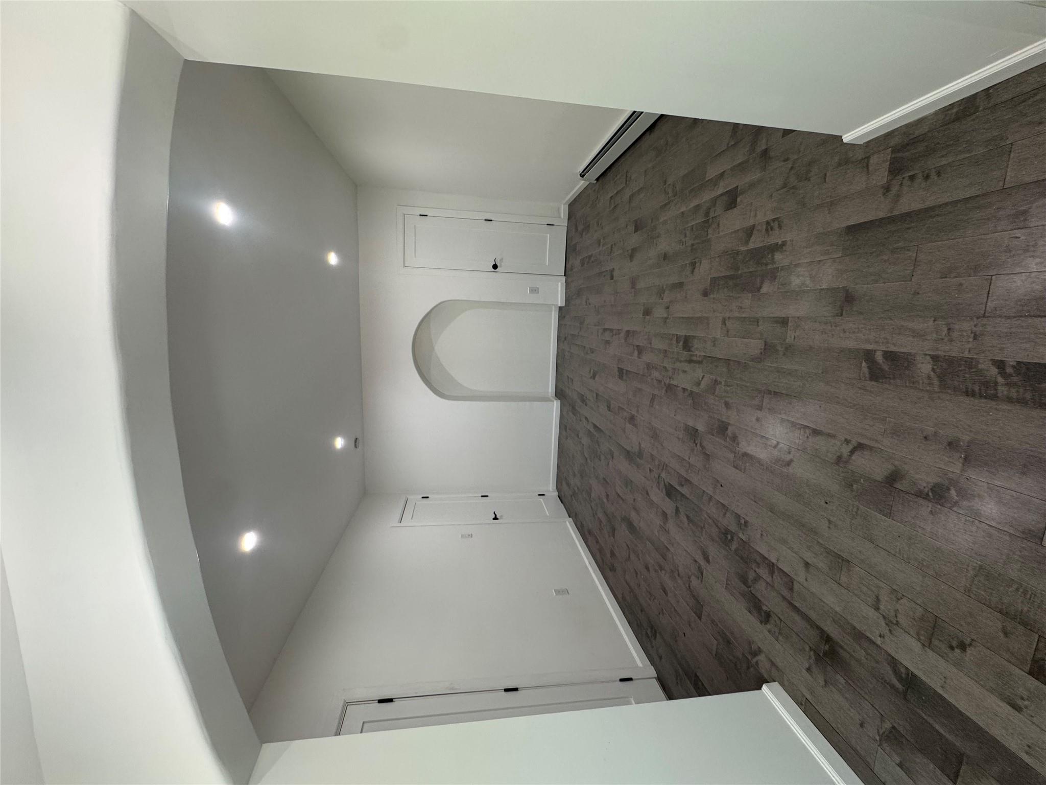 179-55 Anderson Road Queens, NY 11434 - Photo 8 of 14 Spare room featuring baseboard heating, dark wood finished floors, recessed lighting, and arched walkways