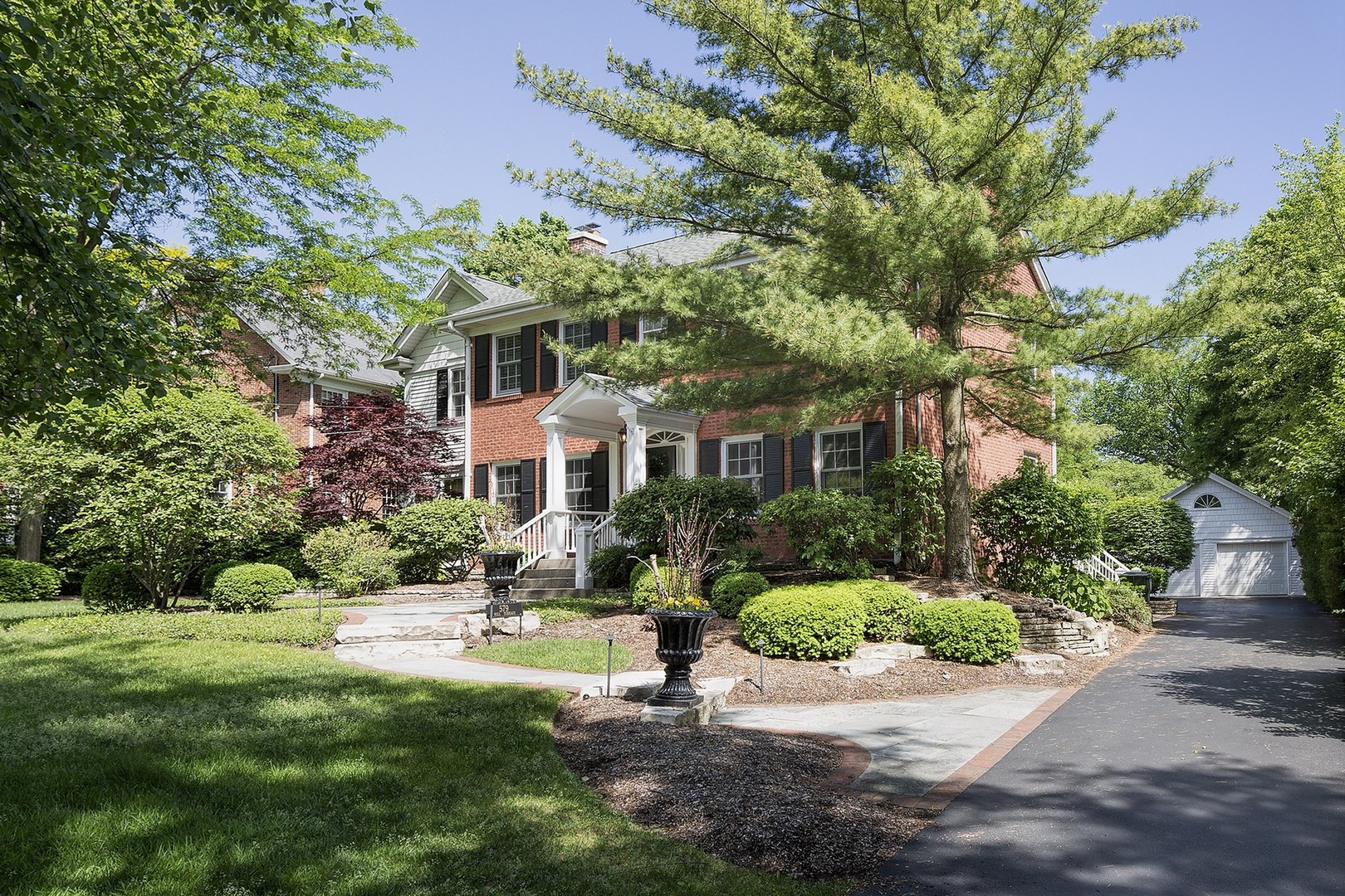 579 Hill Terrace Winnetka, IL 60093 - Photo 1 of 31 a front view of a house with a yard