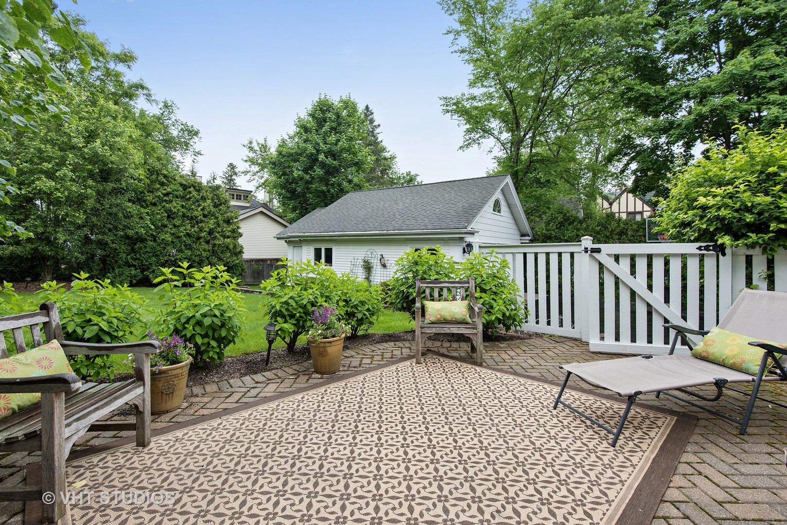 579 Hill Terrace Winnetka, IL 60093 - Photo 23 of 31 a view of a chairs and table in the back yard of a house