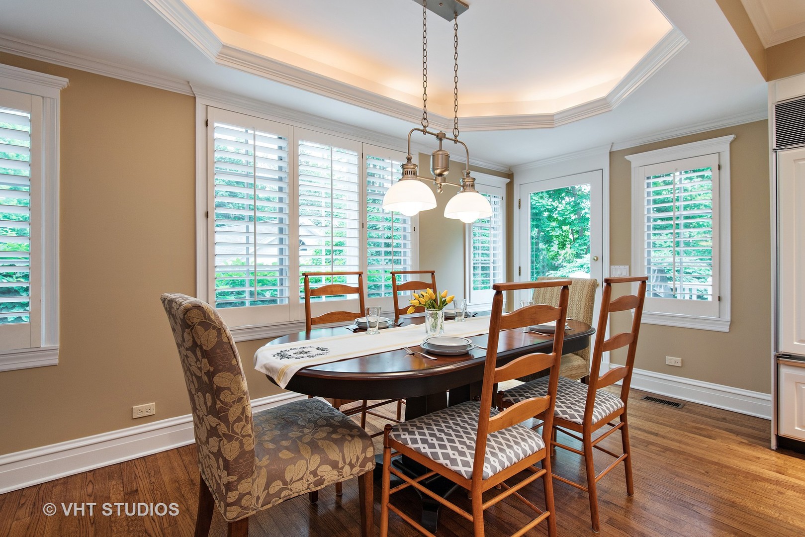 579 Hill Terrace Winnetka, IL 60093 - Photo 10 of 31 a dining room with furniture a chandelier and wooden floor