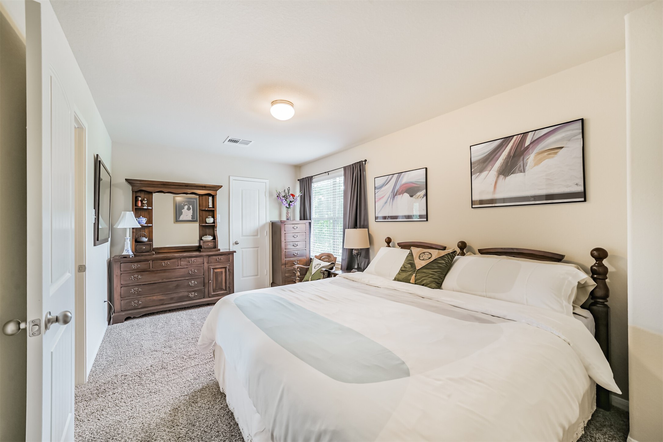 12009 La Salle River Road Conroe, TX 77304 - Photo 35 of 50 a bedroom with a large bed and furniture