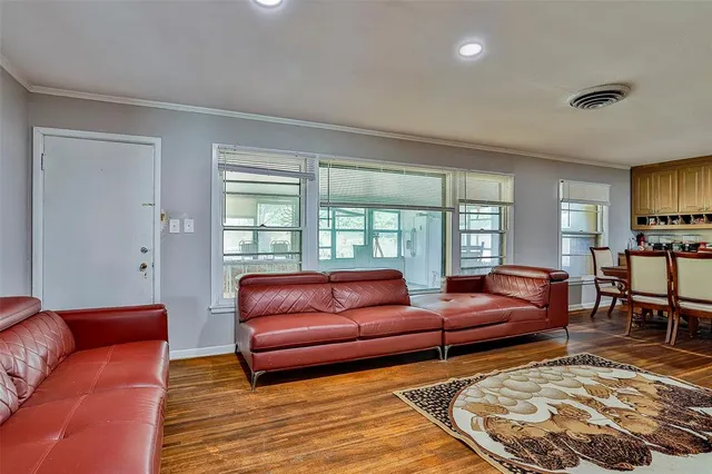 a kitchen with granite countertop a sink cabinets stainless steel appliances and a window