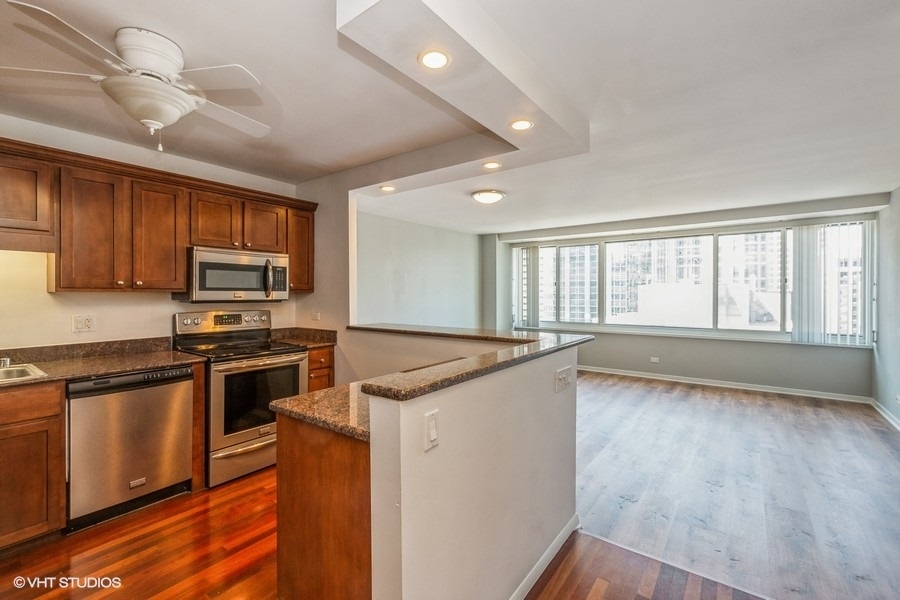 Undisclosed Address Chicago, IL 60611 - Photo 2 of 19 a kitchen with stainless steel appliances granite countertop a stove a sink and a refrigerator