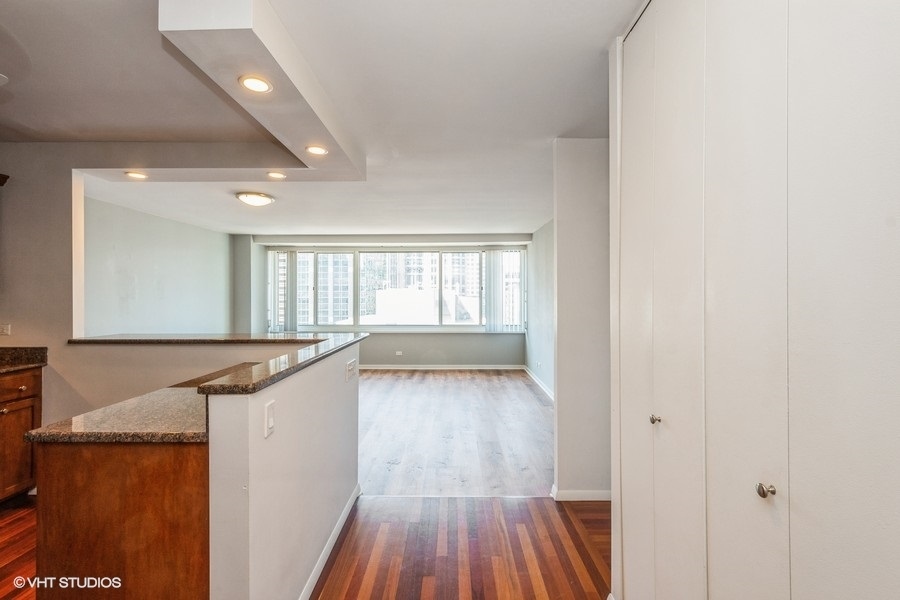 Undisclosed Address Chicago, IL 60611 - Photo 3 of 19 a view of a kitchen with a sink and wooden floor