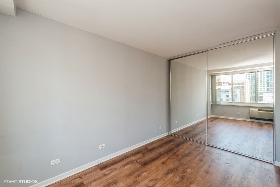 Undisclosed Address Chicago, IL 60611 - Photo 8 of 19 wooden floor in an empty room with a window