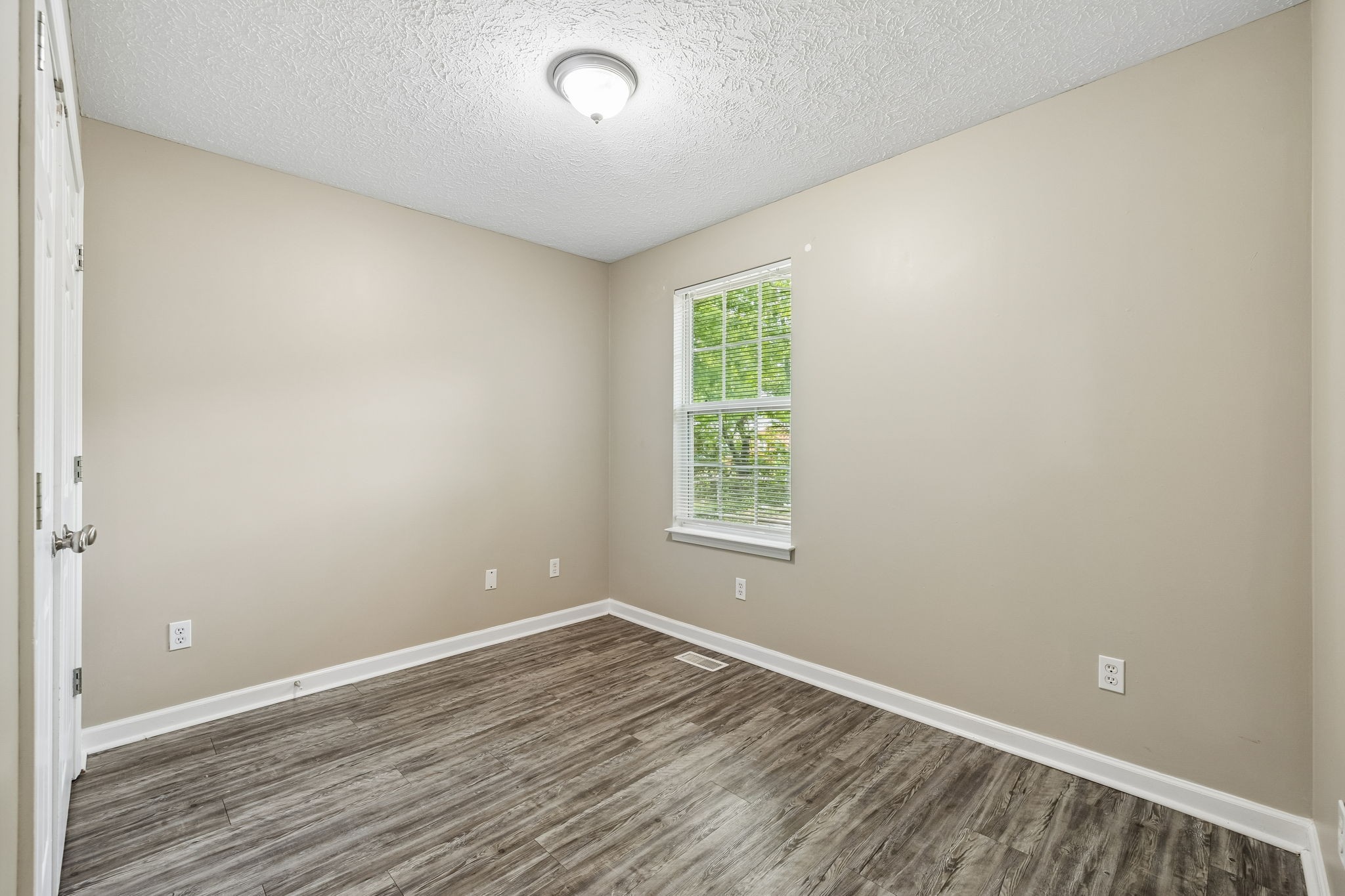 511 Hayes Street Springfield, TN 37172 - Photo 15 of 26 an empty room with wooden floor and windows