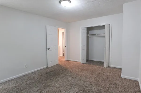 a view of an empty room and a window