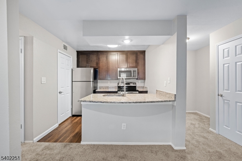 690 Route 23 Wayne Nj 07470, Unit R1 Wayne, NJ 07470 - Photo 2 of 8 a view of kitchen with stainless steel appliances granite countertop cabinets and a refrigerator