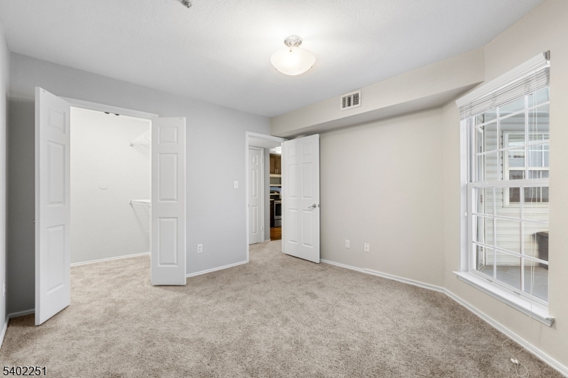 690 Route 23 Wayne Nj 07470, Unit R1 Wayne, NJ 07470 - Photo 6 of 8 a view of an empty room with a window