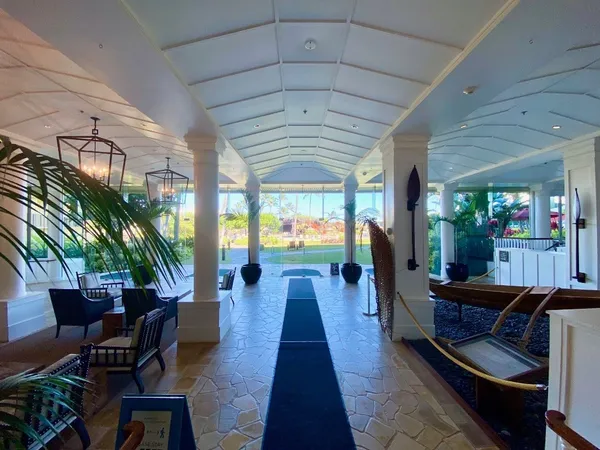 a lobby with furniture and a potted plant