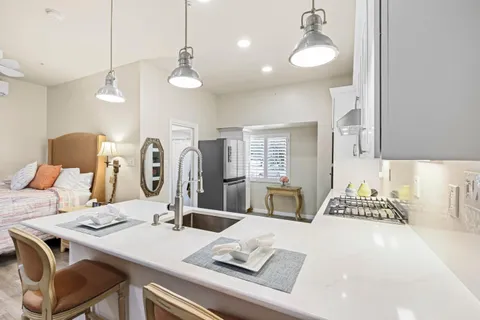 a kitchen with a sink stove and microwave