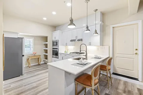 a kitchen with cabinets and window