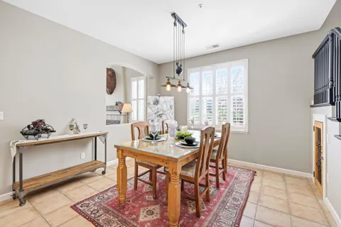 a living room with patio furniture and a wooden floor