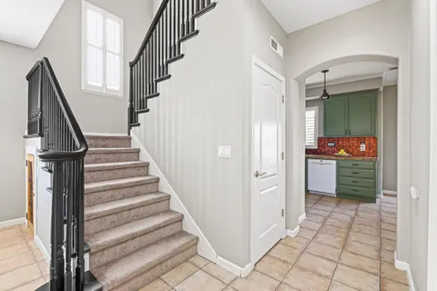 a kitchen with granite countertop white cabinets and stainless steel appliances
