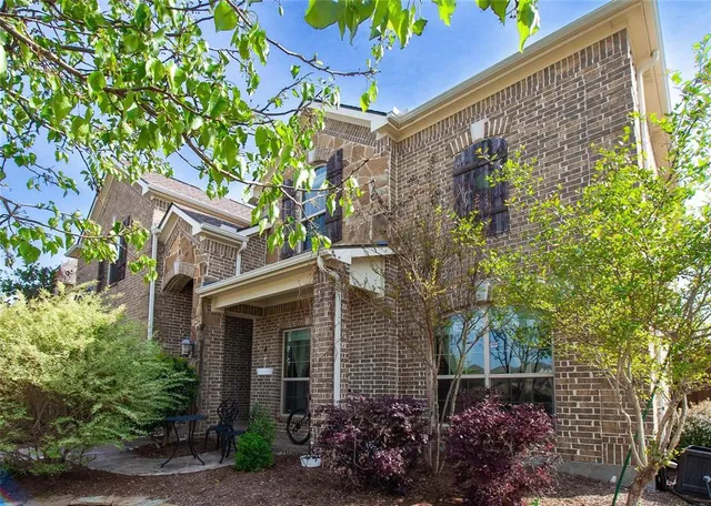 front view of a house with a tree