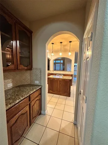a kitchen with a sink a stove and cabinets