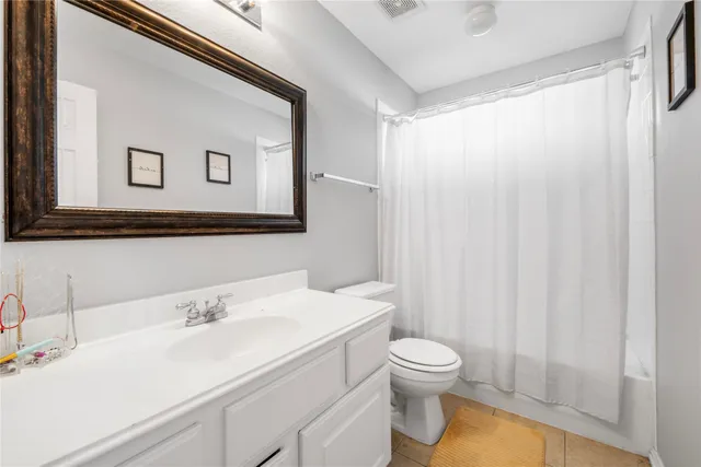 a bathroom with a sink mirror and a toilet