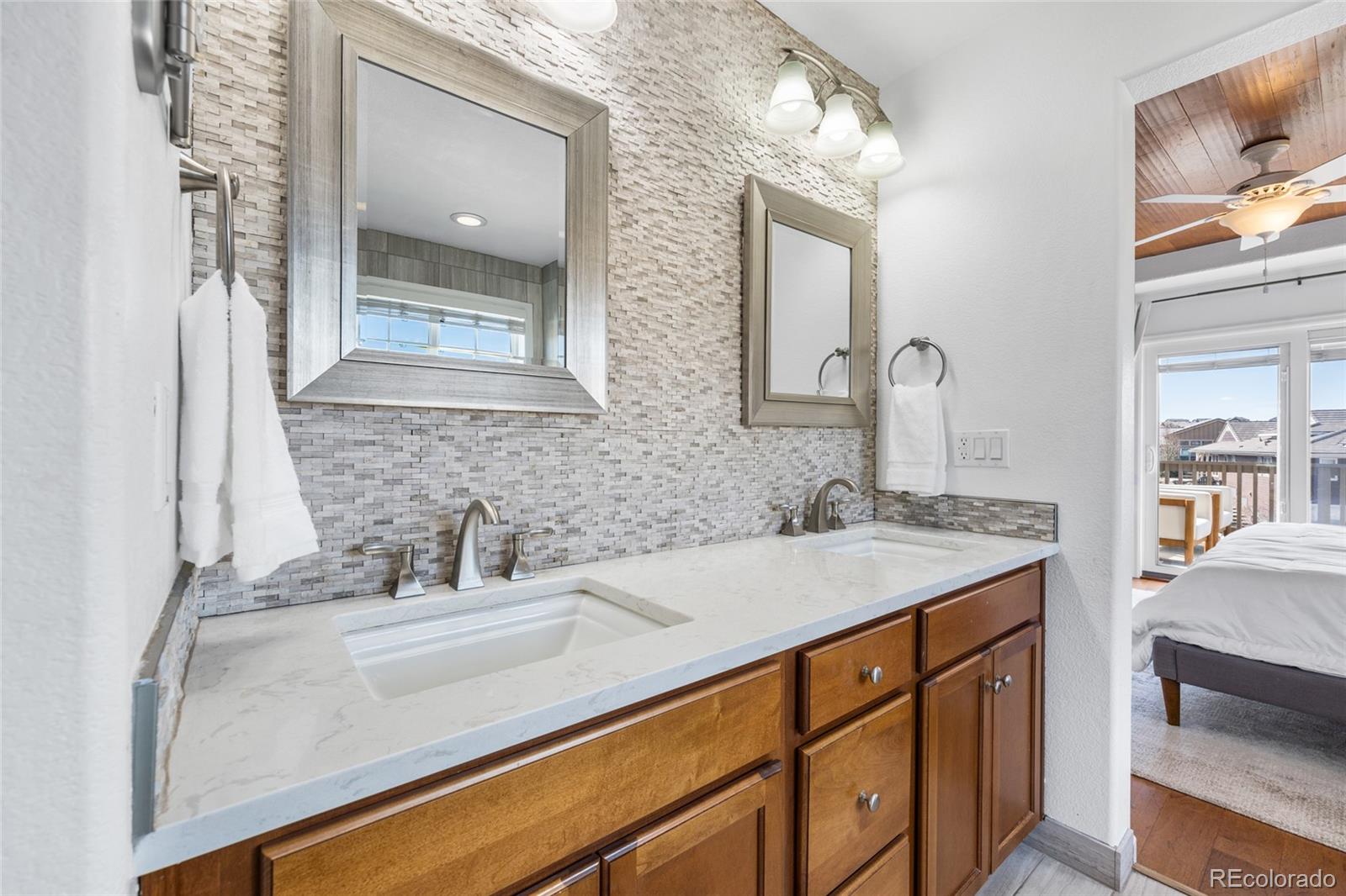 10451 Meadowleaf Way Highlands Ranch, CO 80126 - Photo 17 of 39 a bathroom with a sink and a mirror