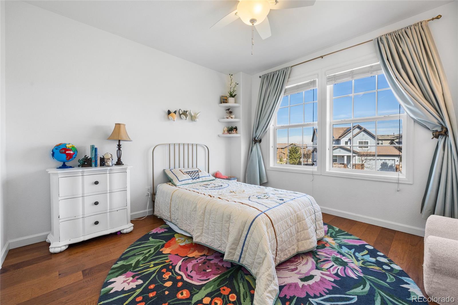 10451 Meadowleaf Way Highlands Ranch, CO 80126 - Photo 19 of 39 a bedroom with a bed and a window