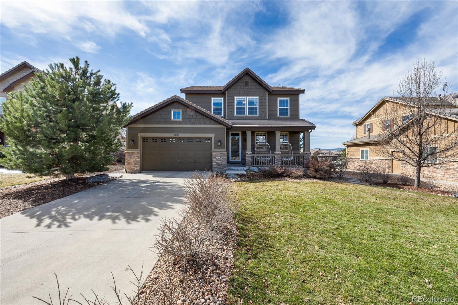 10451 Meadowleaf Way Highlands Ranch, CO 80126 - Photo 2 of 39 a front view of a house with a yard and garage