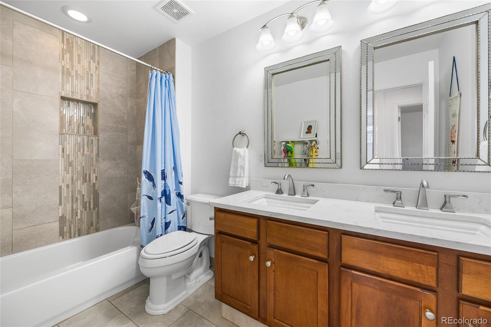 10451 Meadowleaf Way Highlands Ranch, CO 80126 - Photo 21 of 39 a bathroom with a sink toilet and shower