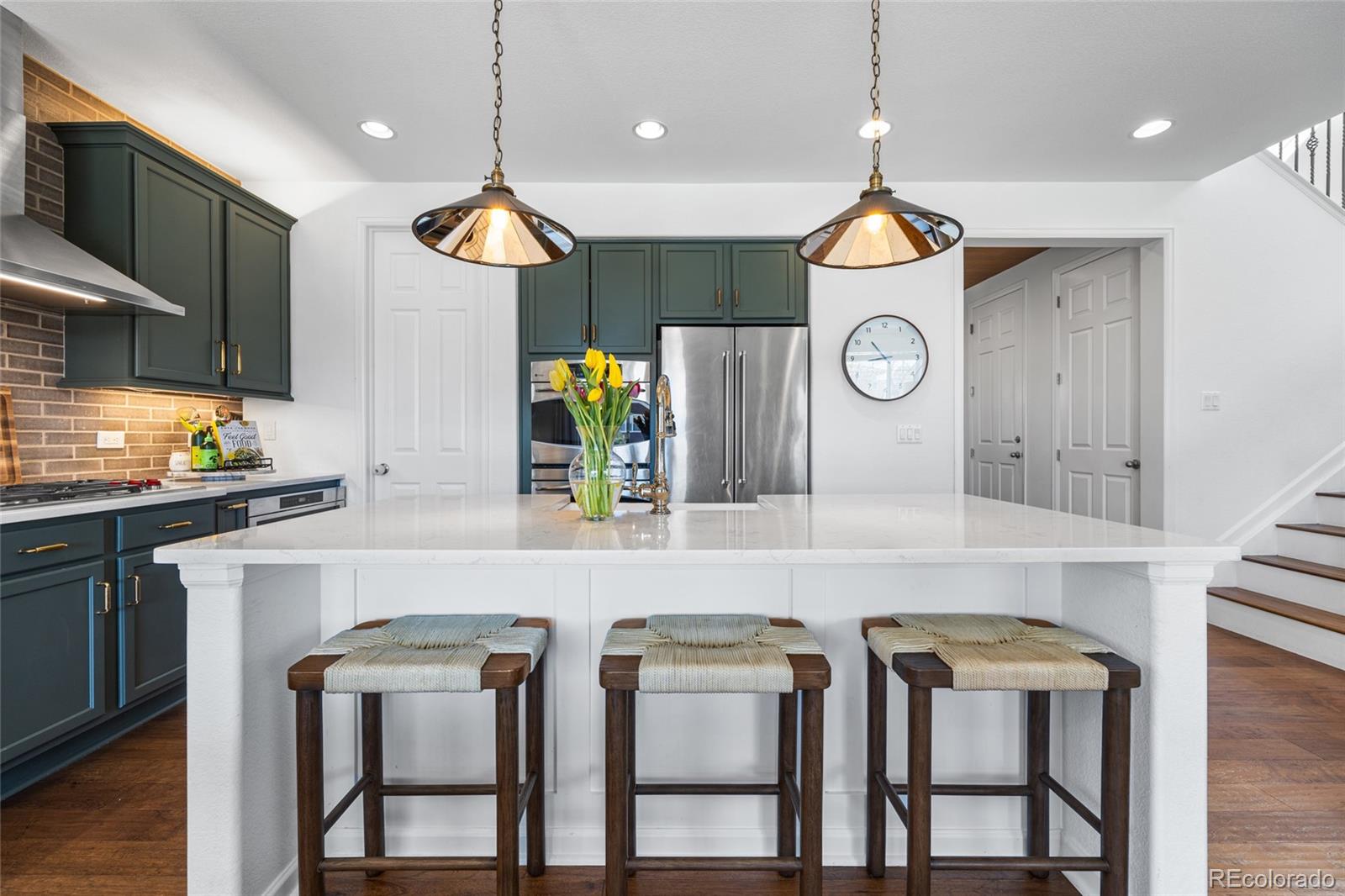 10451 Meadowleaf Way Highlands Ranch, CO 80126 - Photo 6 of 39 a kitchen with furniture and a clock