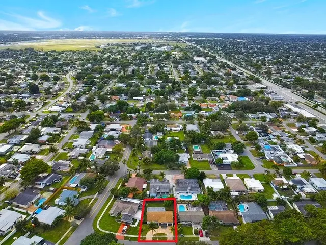 an aerial view of residential houses with city view