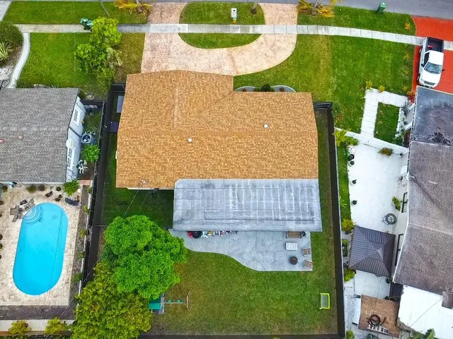 an aerial view of a house with a swimming pool
