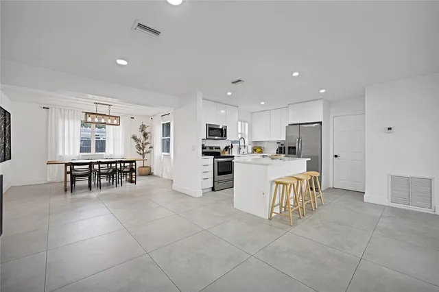 a view of kitchen with microwave and refrigerator
