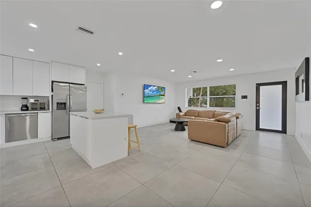 a living room with furniture and kitchen view