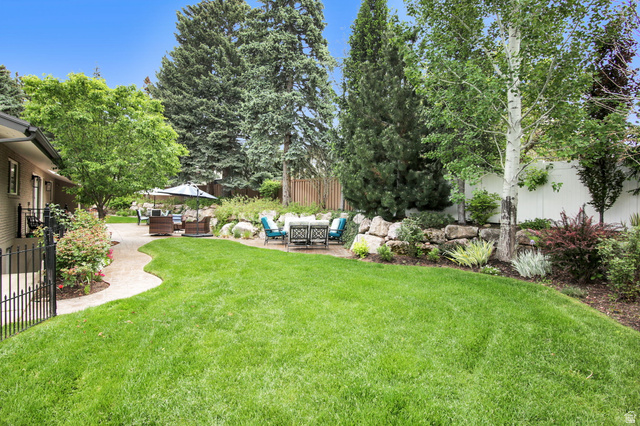 1350 Canyon Park Road Bountiful, UT 84010 - Photo 4 of 38 Spacious lawn area with a winding paved pathway leading to multiple outdoor patio areas