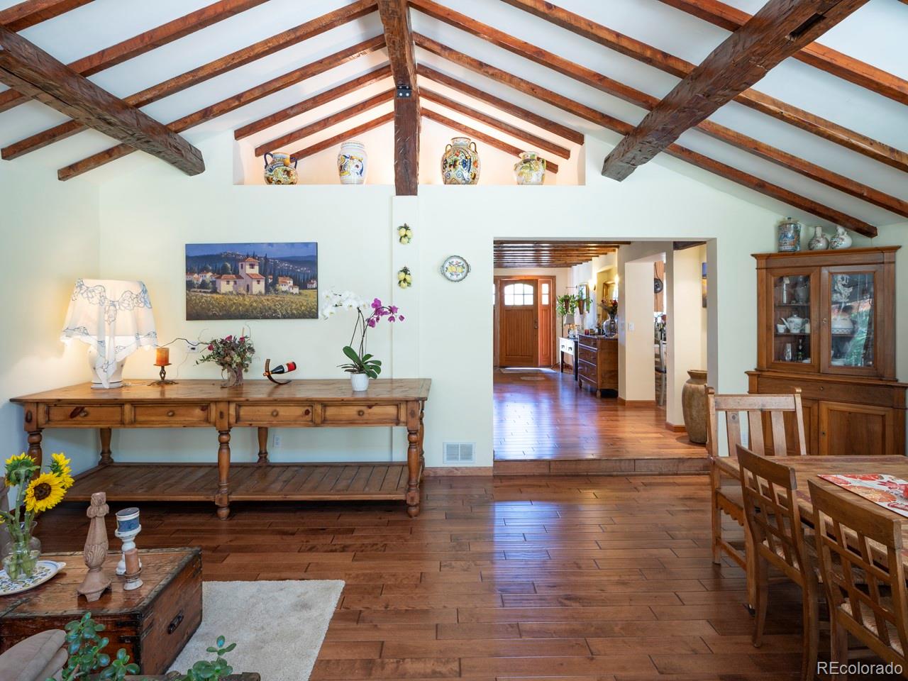 1085 Gapter Road Boulder, CO 80303 - Photo 12 of 24 a view of a hallway with dining room and wooden floor