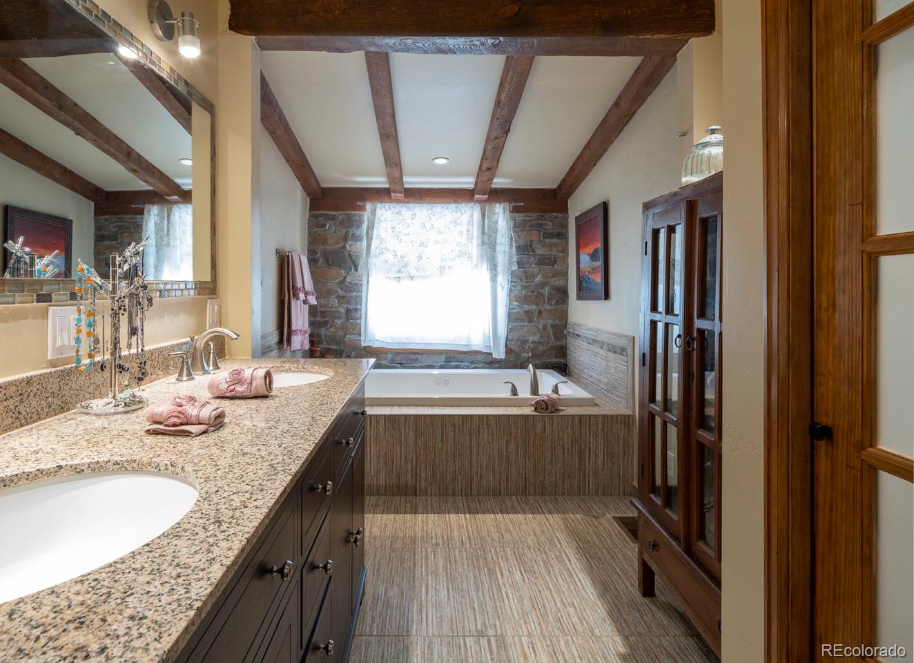 1085 Gapter Road Boulder, CO 80303 - Photo 15 of 24 a bathroom with a granite countertop bathtub shower sink and mirror