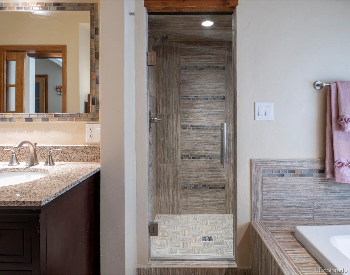 1085 Gapter Road Boulder, CO 80303 - Photo 16 of 24 a bathroom with a granite countertop sink a mirror and shower